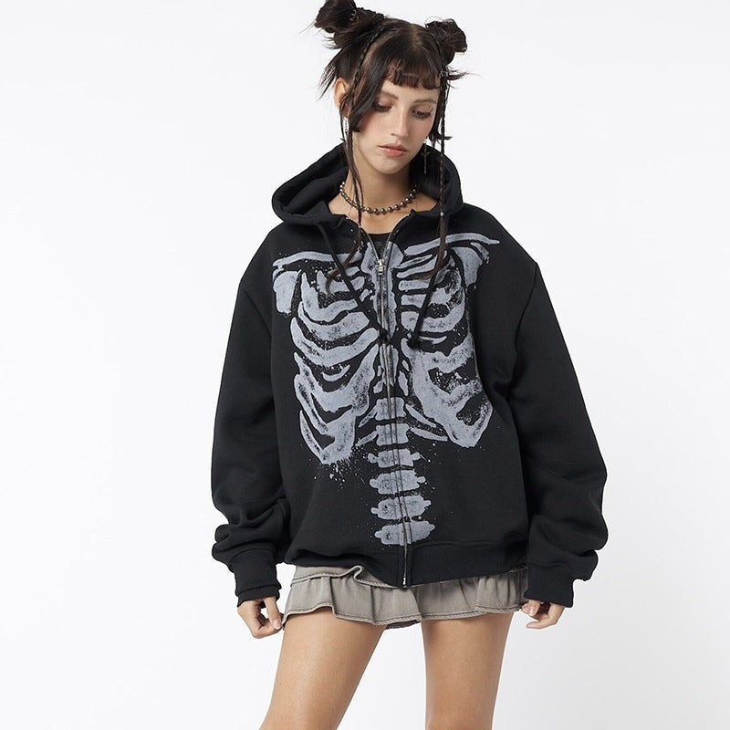 Model wearing black skeleton print zip-up hoodie with oversized hood and sleeves