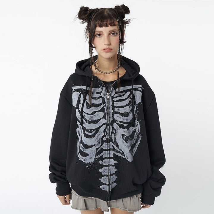 Front view of oversized skeleton print hoodie paired with a pleated mini skirt