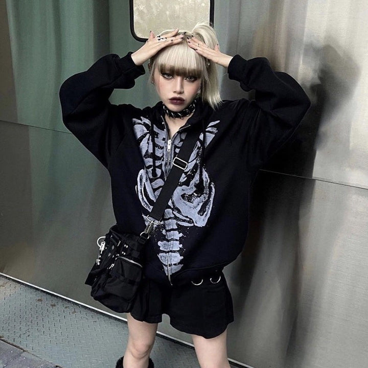 Oversized black skeleton hoodie layered over shorts with a crossbody bag