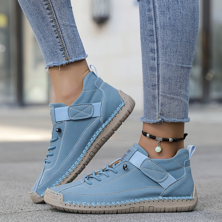 Powder blue leather sneakers with hand-stitched trim and lace-up design