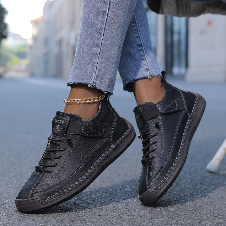 black leather sneakers with rugged sole and adjustable ankle strap