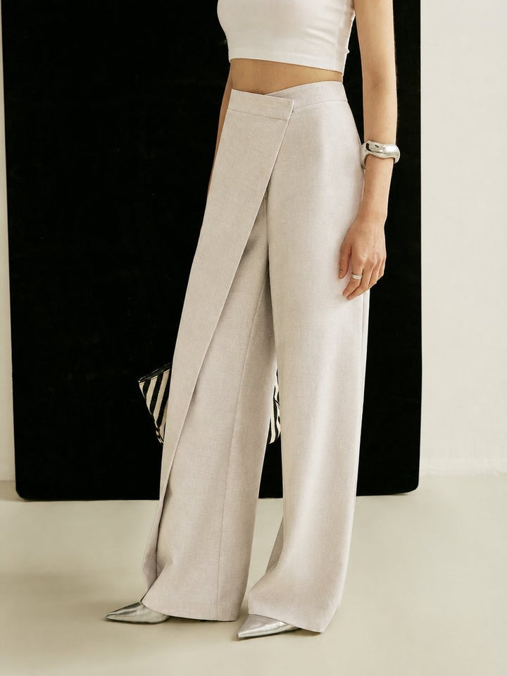 beige wrap-style wide leg trousers shown with striped tote bag