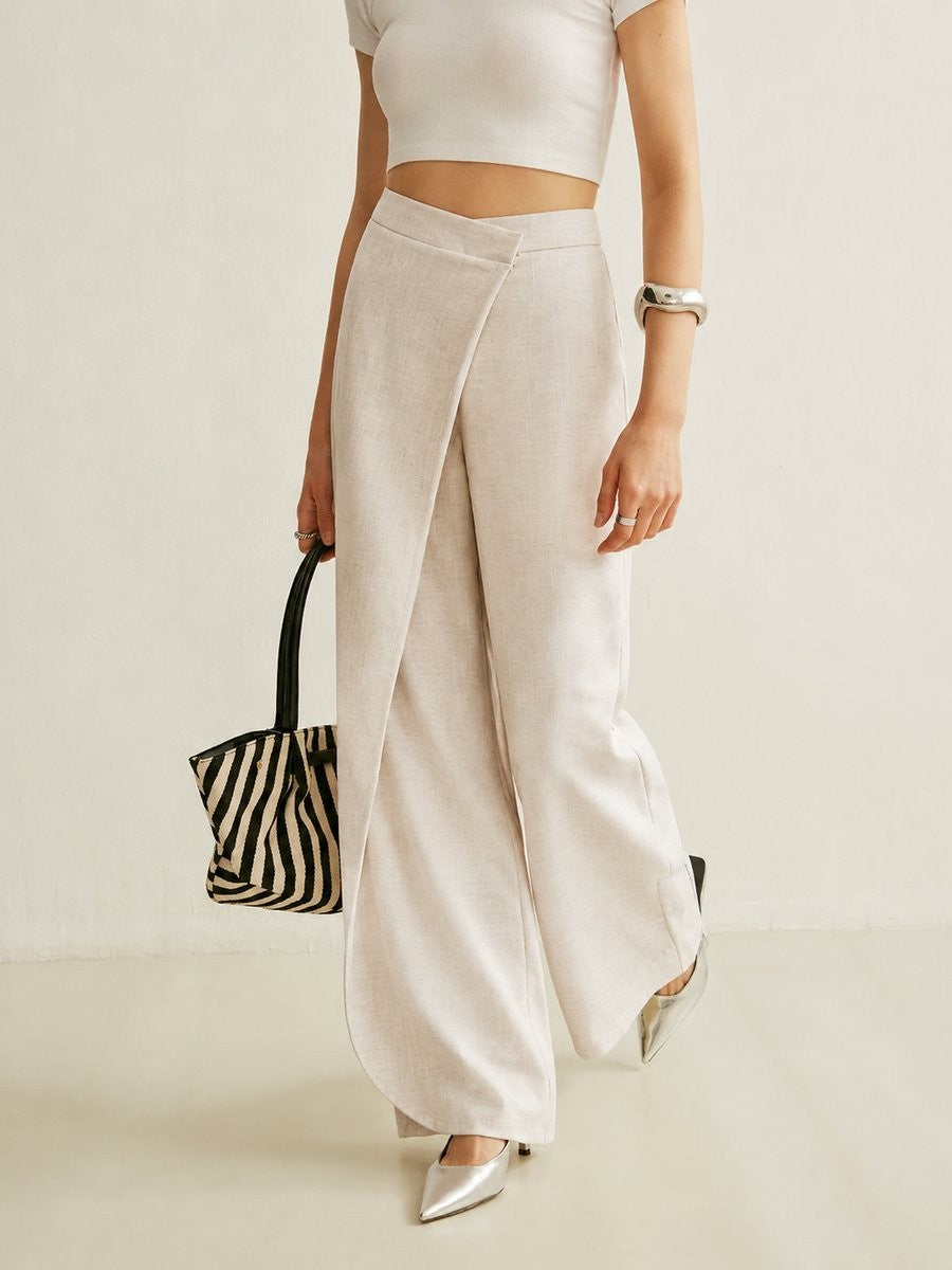 model walking in beige asymmetric wrap wide leg pants