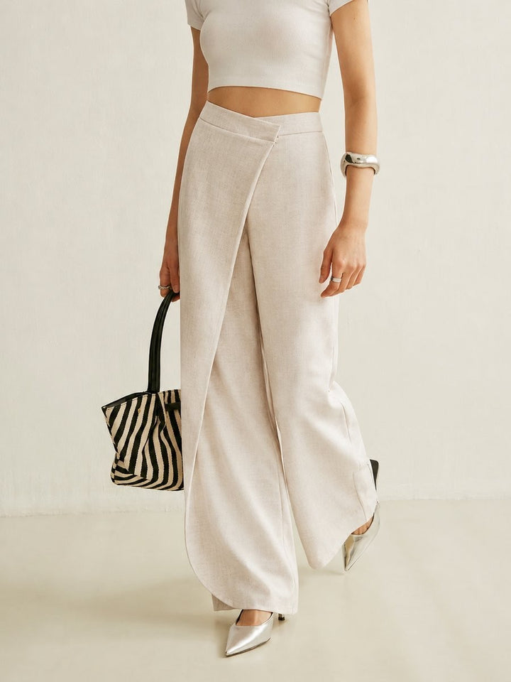 model walking in beige asymmetric wrap wide leg pants