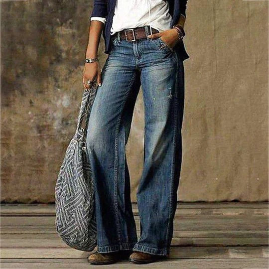 Faded blue wide leg denim jeans styled with a brown leather belt