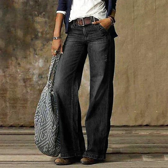 Dark gray wide leg denim jeans paired with a woven shoulder bag