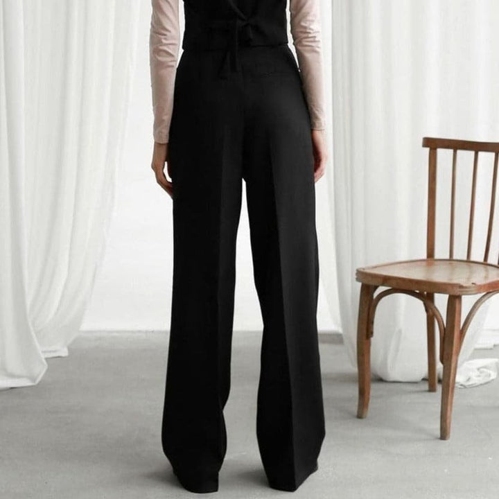 Black wide-leg pants shown from behind with wide hem