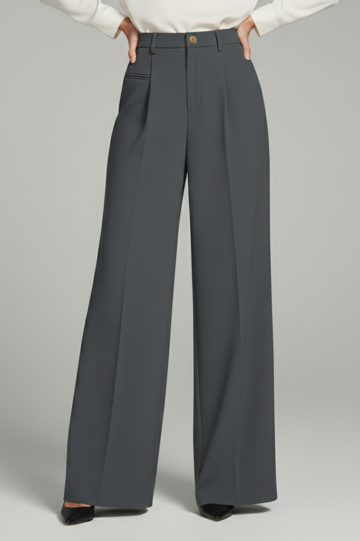 Charcoal gray wide-leg pleated trousers styled with a white blouse and heels