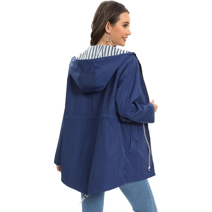 Woman in navy hooded raincoat showing back view with striped lining