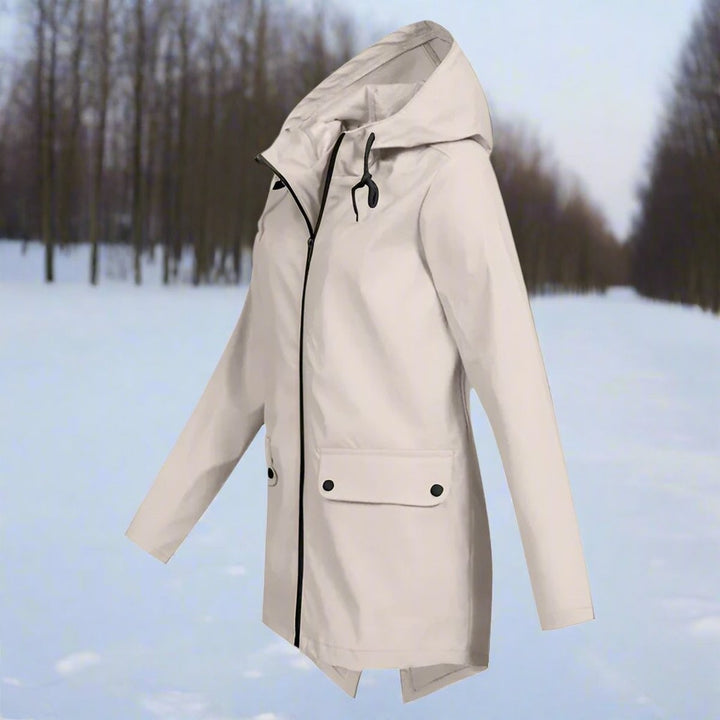 Beige waterproof hooded rain jacket with zip-up longline design, side view