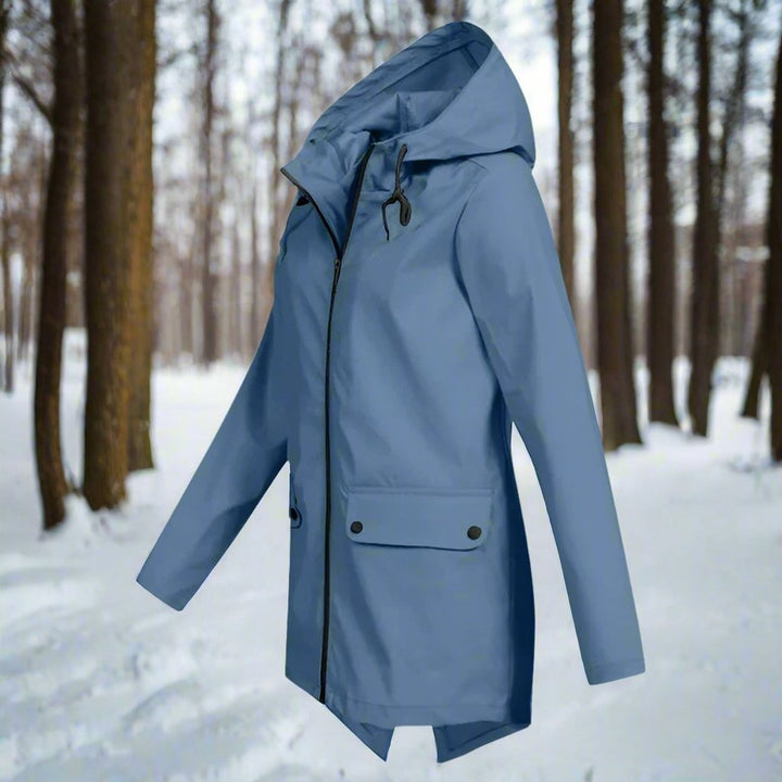 Slate blue zip-up rain jacket with hood, side profile against snowy woods