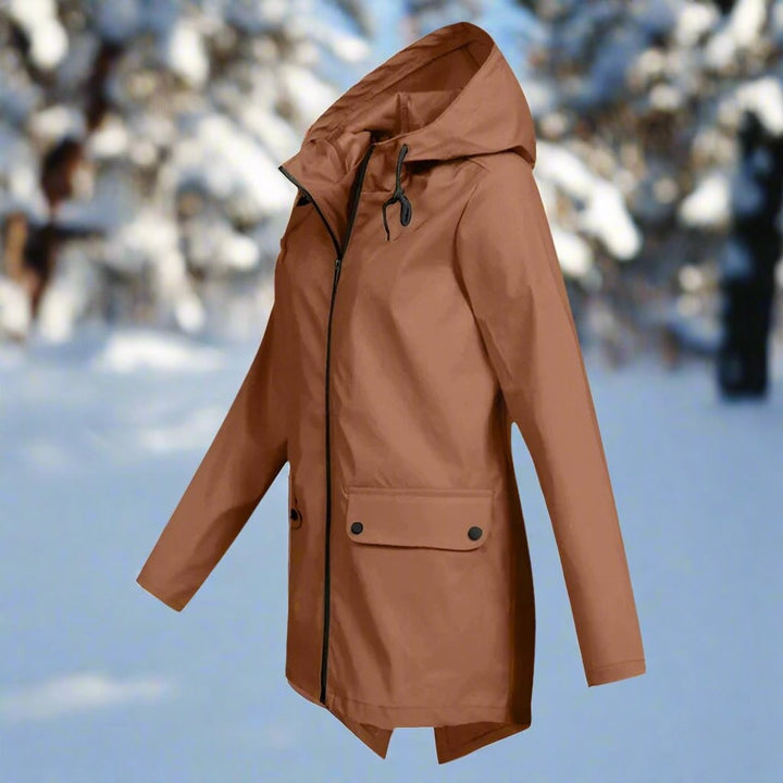 Rust brown hooded rain jacket with zip front, side view in snowy woods
