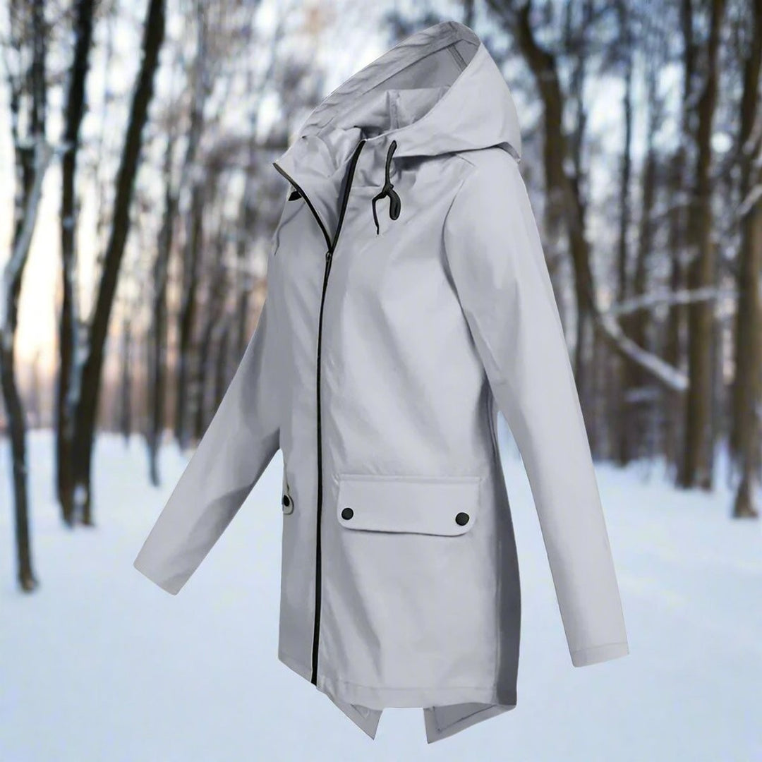 Light gray zip-up hooded rain jacket, side view in snowy forest