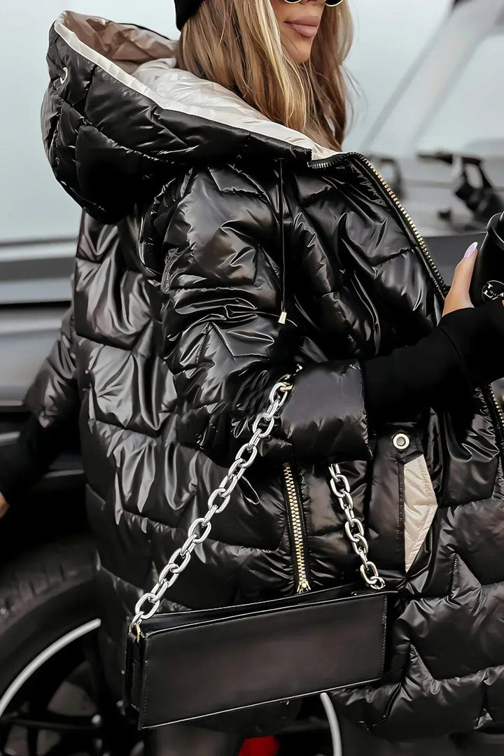 close-up of black high-shine puffer coat with beige interior hood lining