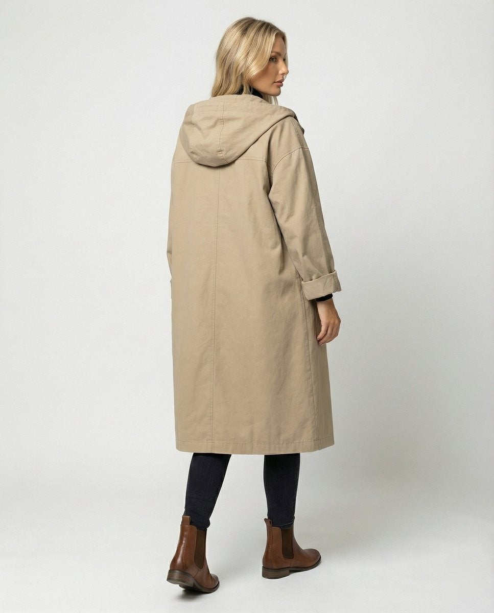 Rear view of beige longline hooded trench coat with turn-back cuffs