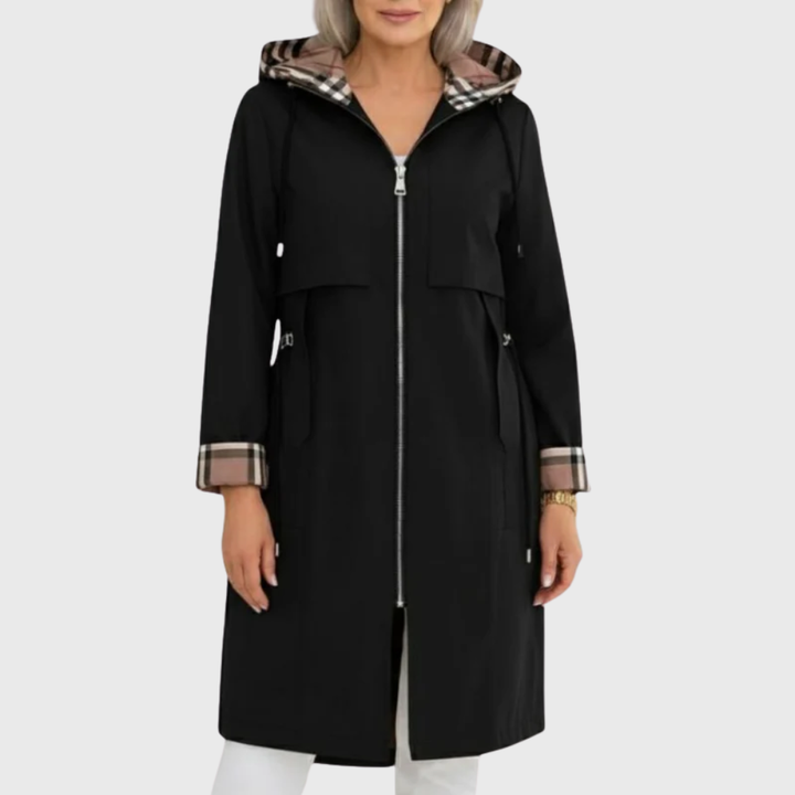 Black hooded trench coat featuring plaid-lined hood and cuffs