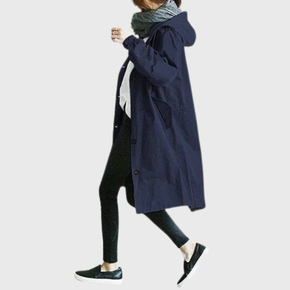 Navy hooded trench coat with drawstring waist shown in side profile