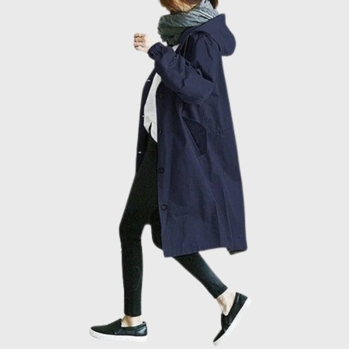 Navy hooded trench coat with drawstring waist shown in side profile
