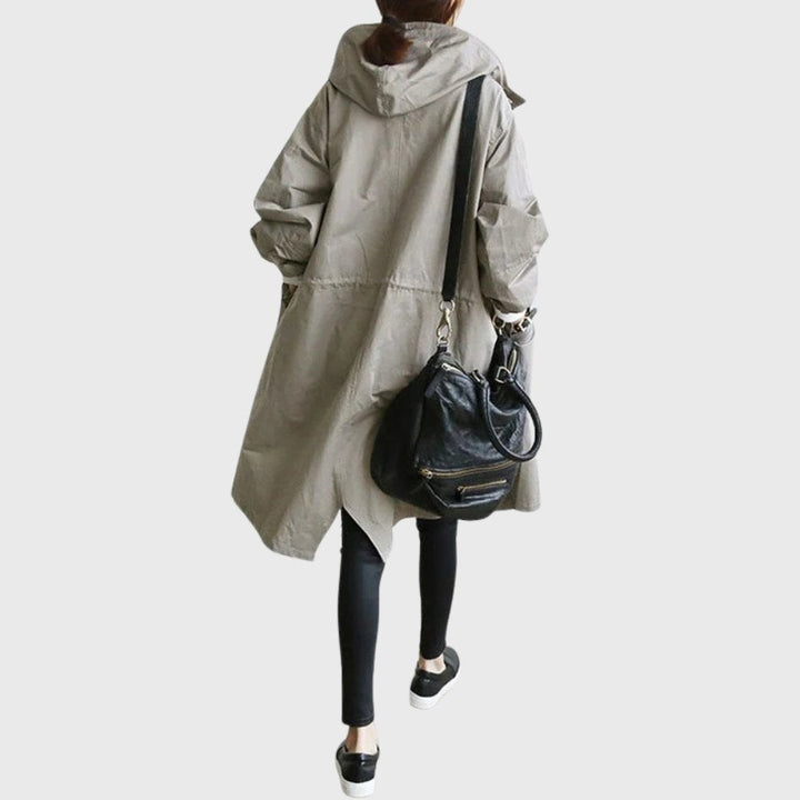 Taupe oversized hooded trench coat paired with a leather crossbody bag