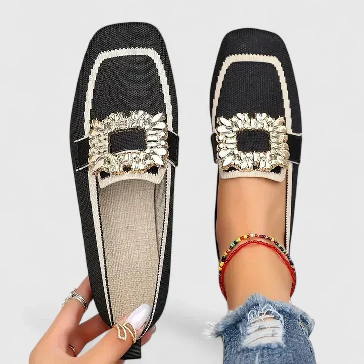 Black knit loafers with cream trim and crystal buckle accent