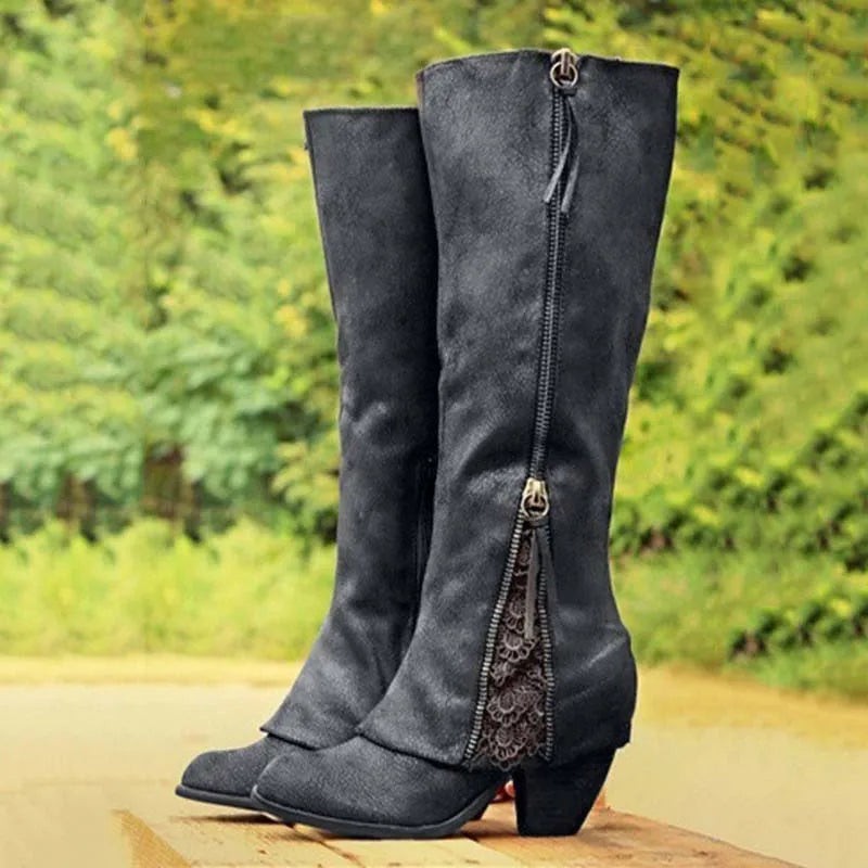 Black knee-high boots featuring chunky heel and lace zipper accent