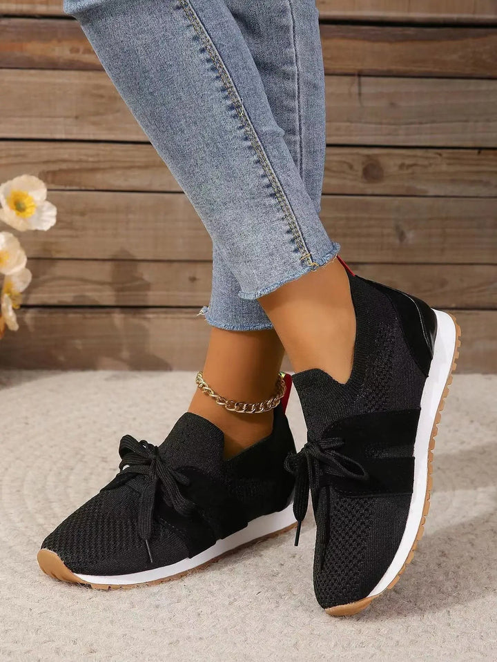 black knit slip-on sneakers with bow lace detail and gum sole