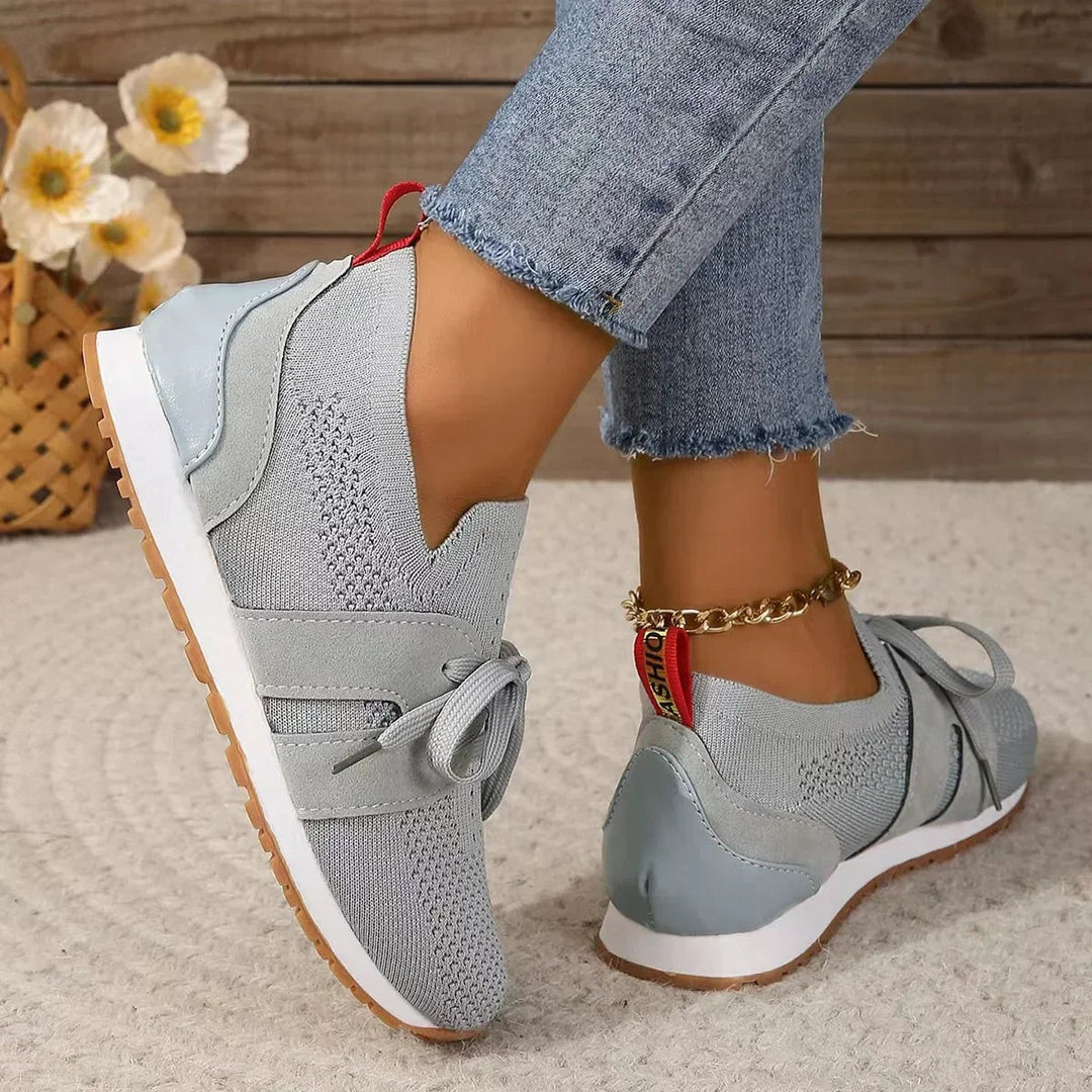 light gray slip-on sneakers featuring V-cut ankle and gum outsole