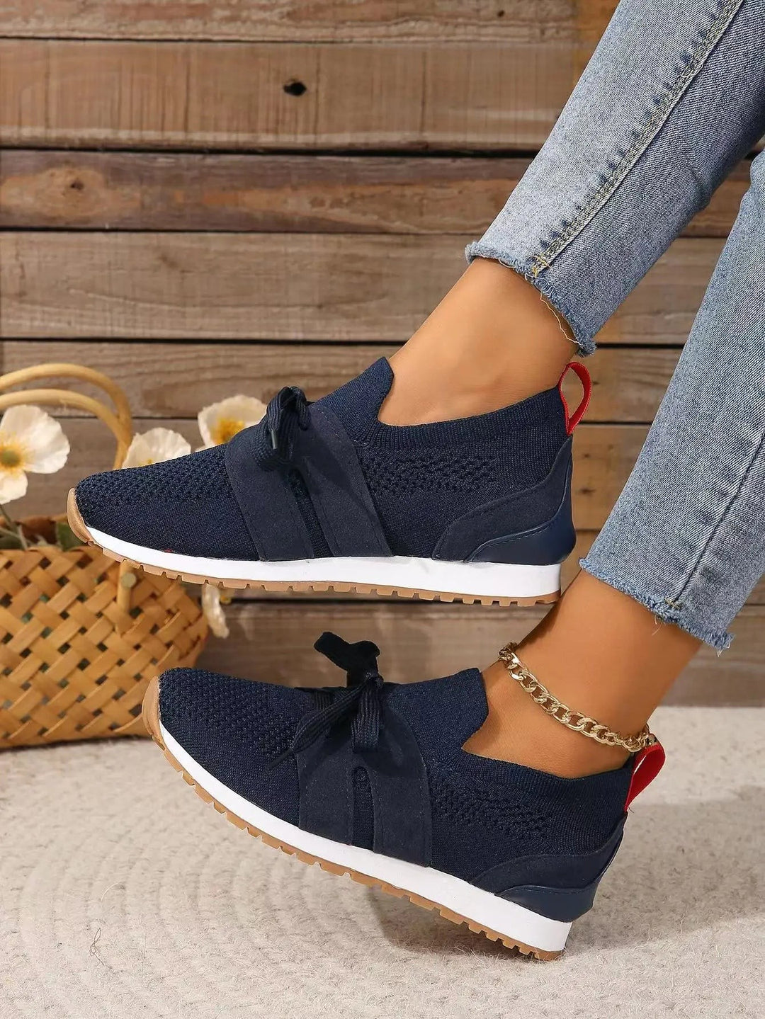 navy knit sneakers with V-cut vamp and red pull-tab heel