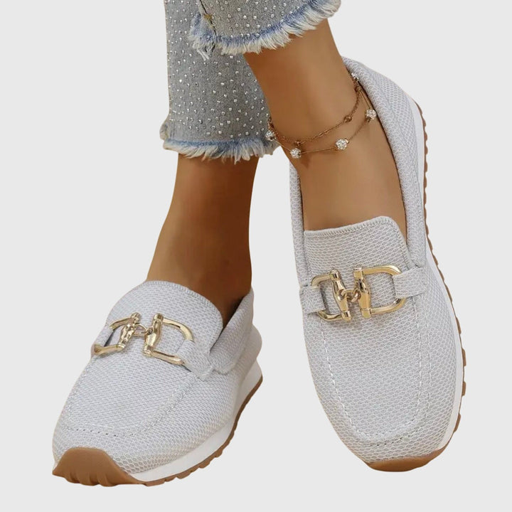 Blue mesh slip-on loafers with gold trim, side profile view