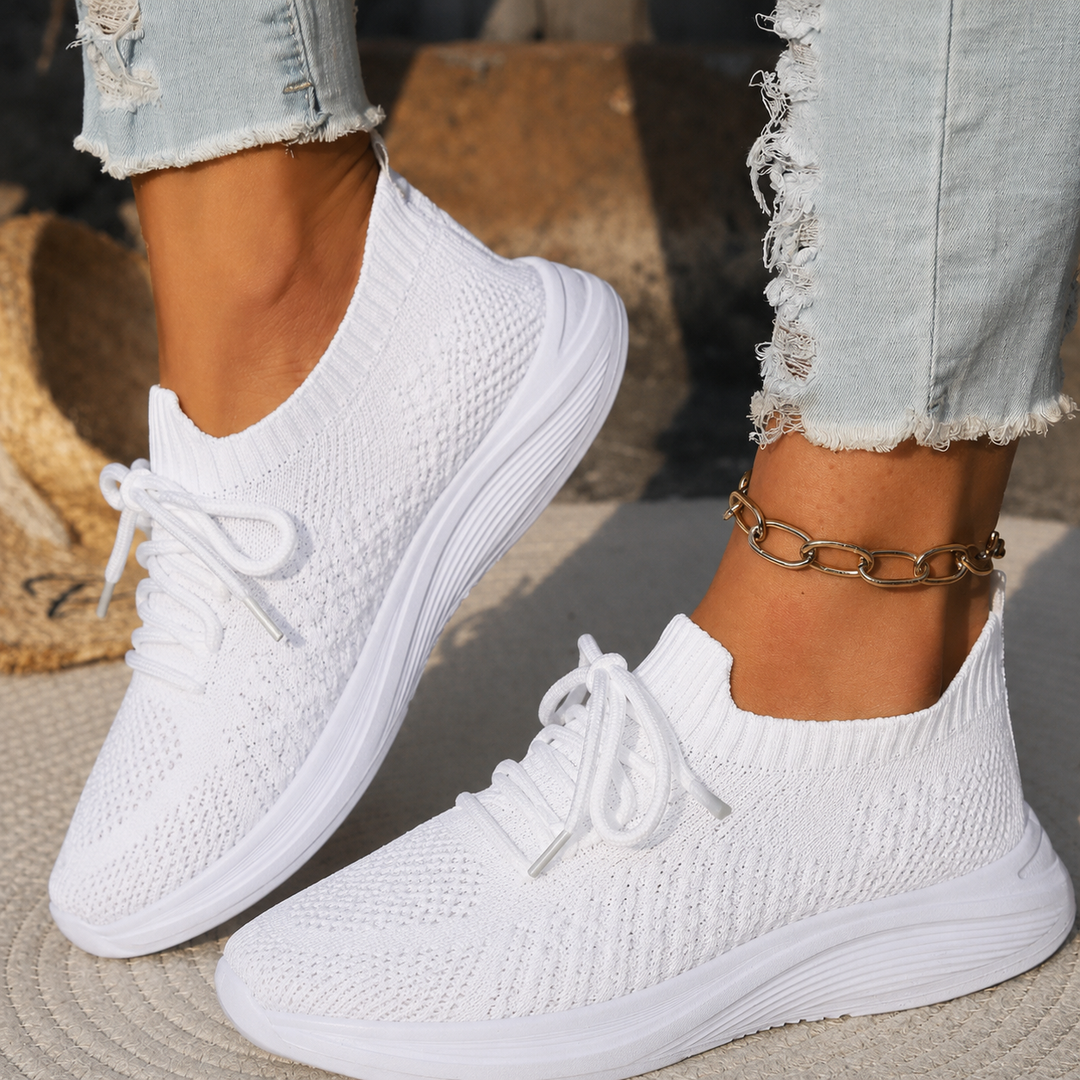 White knit sock-style sneakers with lace-up front and cushioned sole