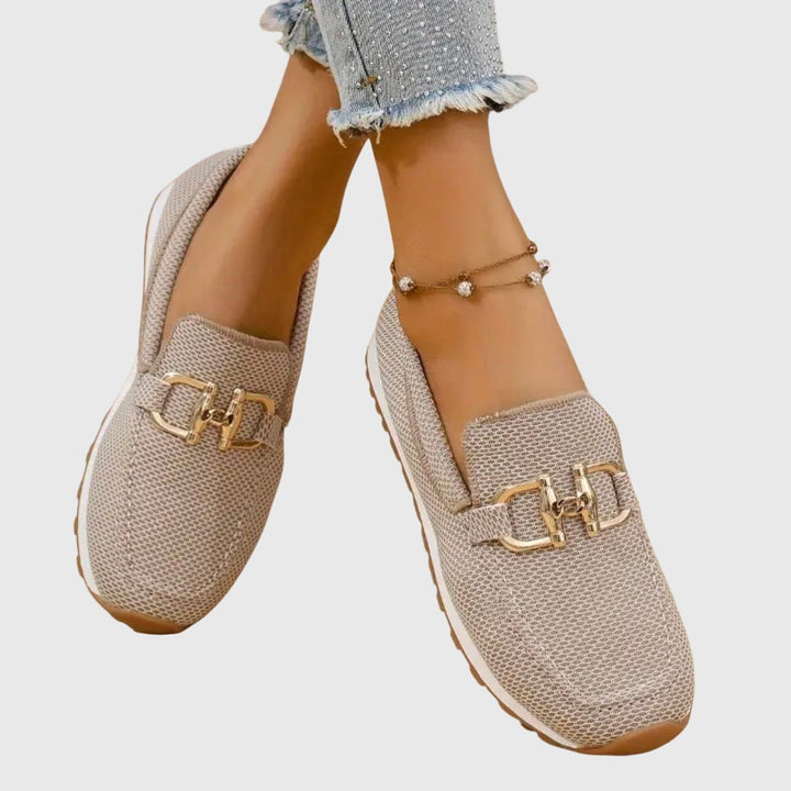 beige knit loafers featuring gold horsebit buckle and white platform sole