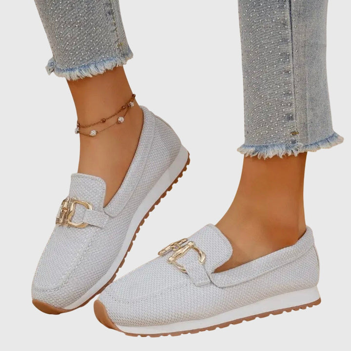 light gray knit loafers with gold buckle trim and rubber outsole