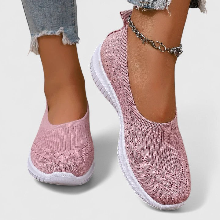 Pink knit slip-on sneakers with scalloped collar and cushioned white outsole