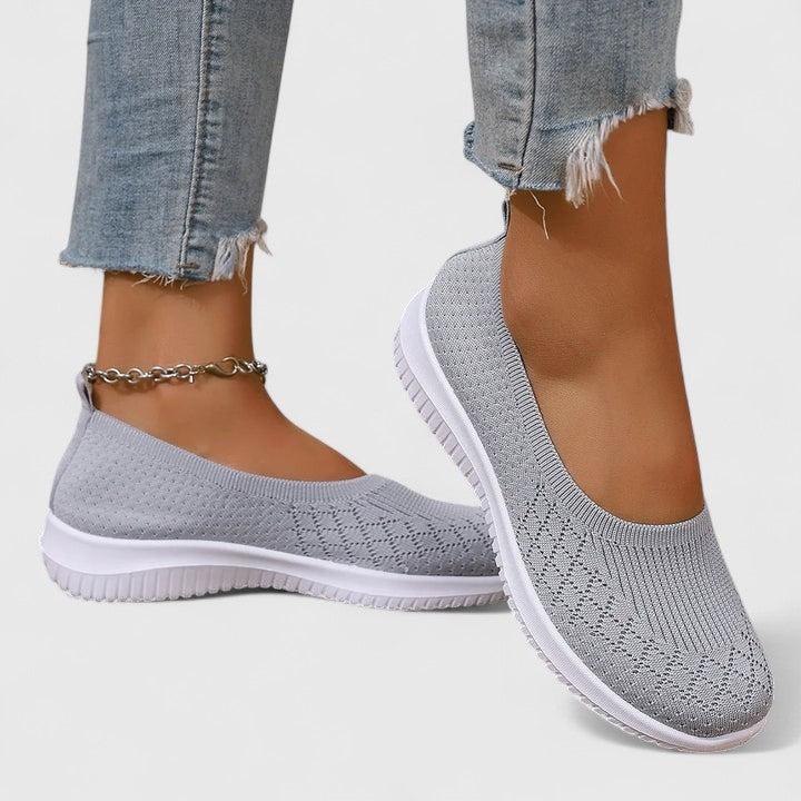 Gray knit slip-on sneakers with breathable mesh upper and white flat sole