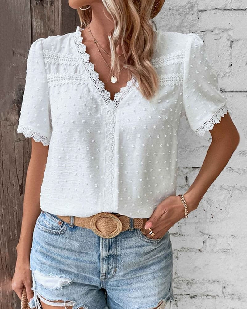 Lace-trim V-neck blouse in white Swiss dot fabric paired with a woven belt