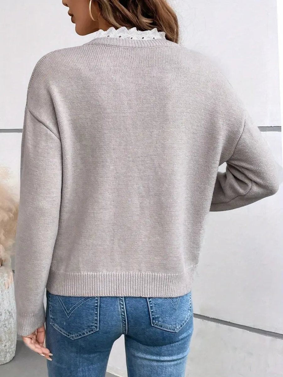 back view of gray lace-trim sweater paired with blue jeans