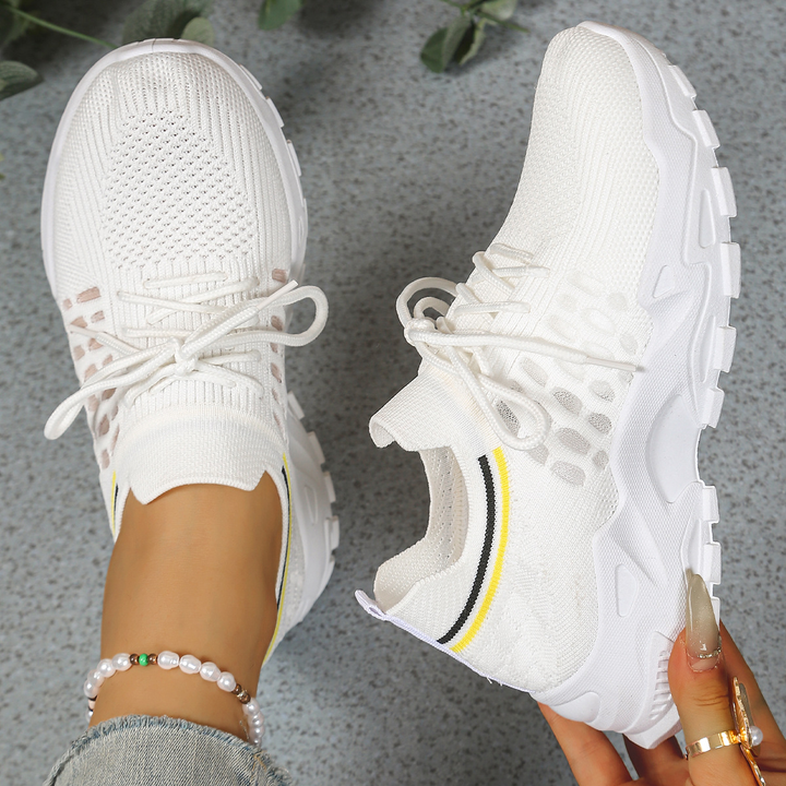 White knit sneakers with perforated cutout design and white platform sole