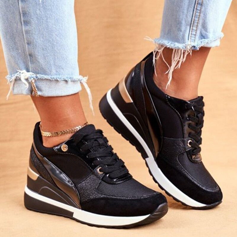 black platform sneakers with metallic accents and lace-up closure