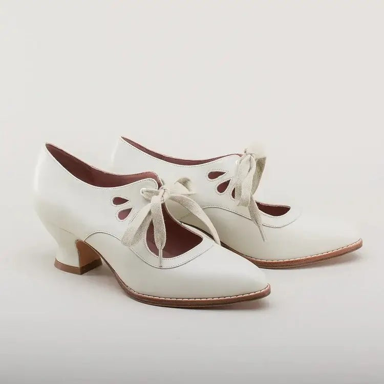 Ivory leather Victorian-style lace-up pumps, product shot on white background