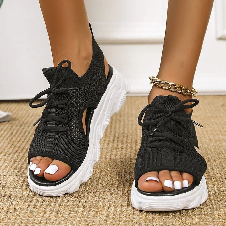 Black knit peep-toe sandals with lace-up front and chunky white platform sole