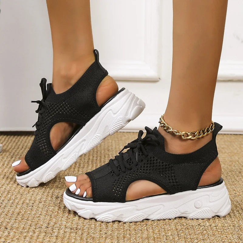 Black woven platform sandals with ankle lacing and open toe design