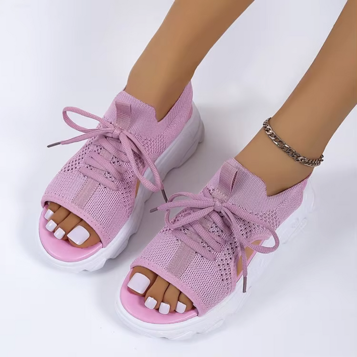 Pink knit platform sandals with lace-up detail and white cushioned sole