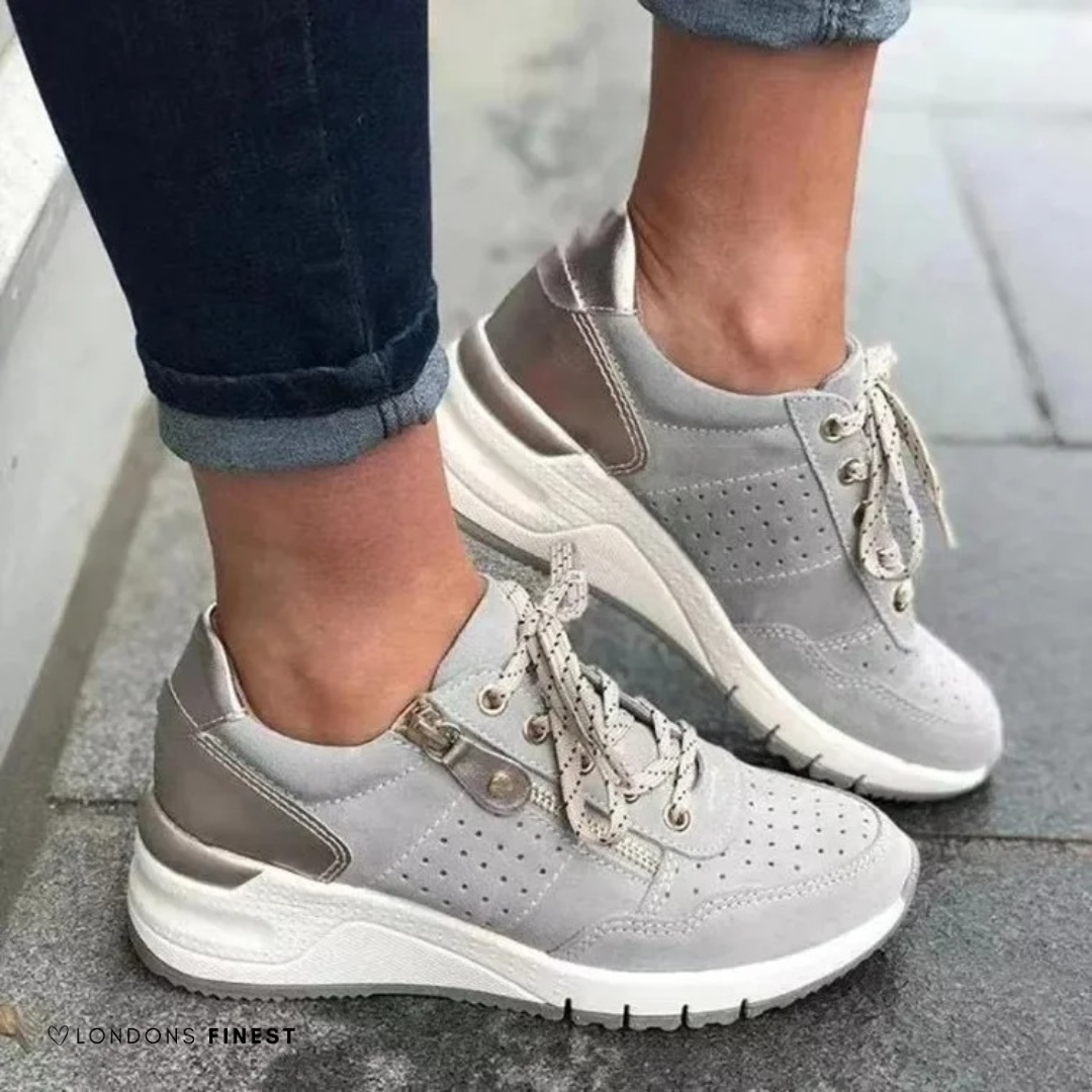 Gray suede lace-up sneakers with metallic heel accent and side zipper