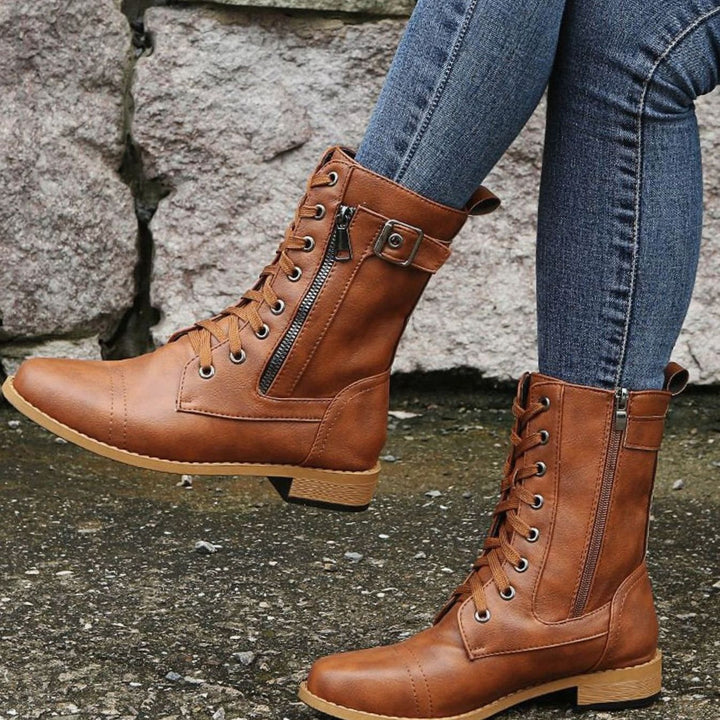 brown lace-up combat boots with cap-toe stitching and side zip
