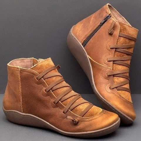 Tan leather ankle boots with crisscross lace detail and side zipper