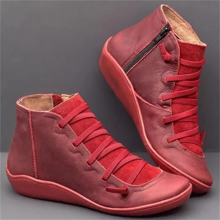 Burgundy leather ankle boots featuring lace-up front and low wedge sole