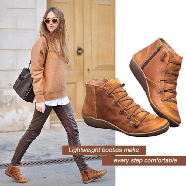 Model wearing tan leather lace-up ankle booties with casual sweater outfit