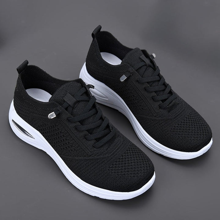 black knit sneakers with lace-up front and contrasting white platform sole