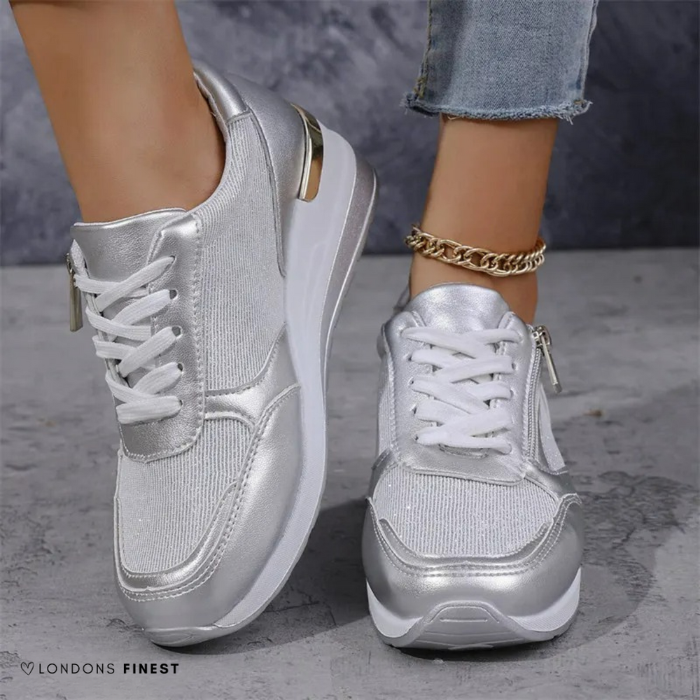 Metallic silver lace-up sneakers featuring side zipper and cushioned platform sole