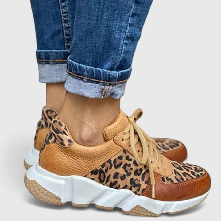 leopard-print chunky sneakers with tan leather trim worn with cuffed jeans
